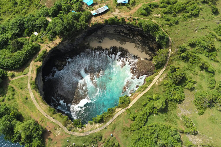 Top view of Broken Beach in Nusa Penida with natural rock arch and blue ocean