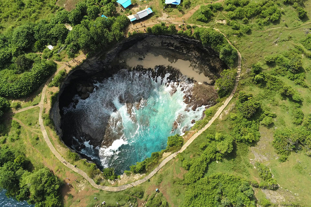 Top view of Broken Beach in Nusa Penida with natural rock arch and blue ocean
