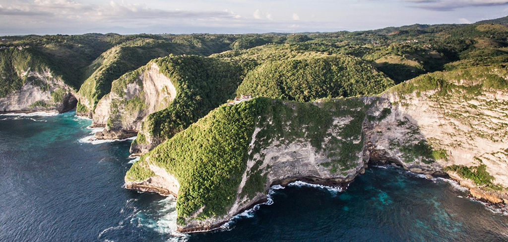 Aerial view of Nusa Penida coastline with dramatic cliffs and turquoise ocean water